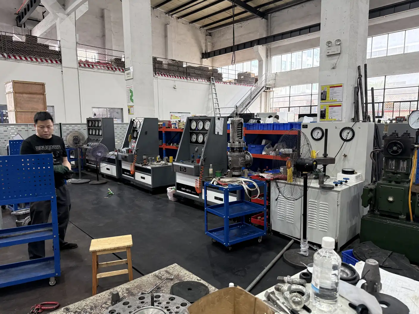ZOBAI technician working beside safety valve test benches