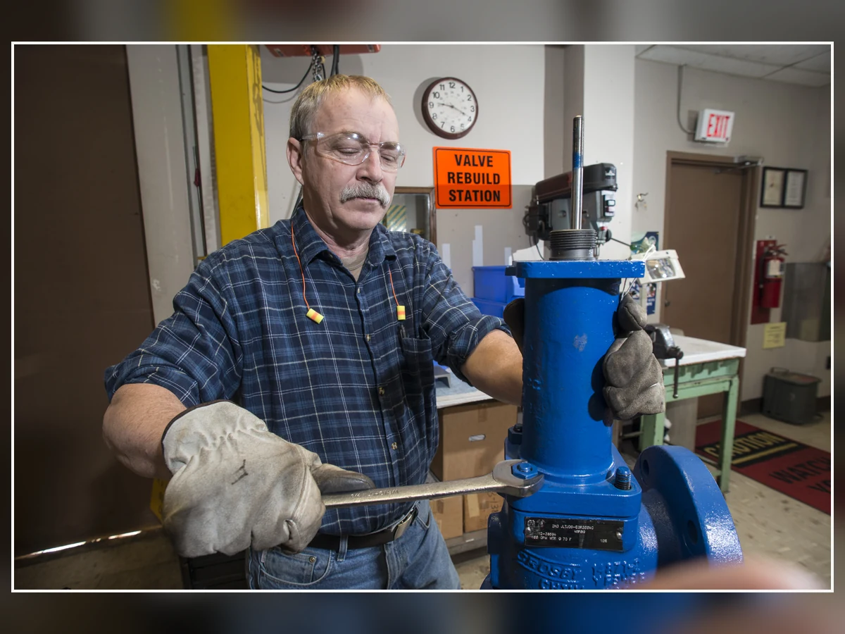 Real Pressure Relief Valve Rebuild Workshop Technician rebuilding a pressure relief valve in a valve workshop